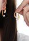 Elegant split design with high gloss pearl inlay simple titanium steel gold-plated earrings