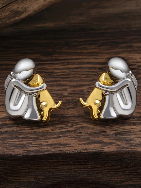 A little girl and a dog embrace earrings